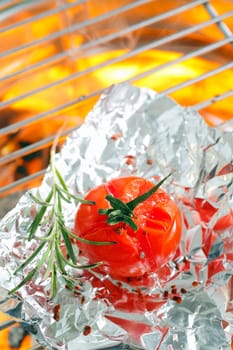 Grilled tomato on aluminium foil on oven grill