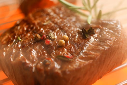 Delicious beef steak, hot barbecue grill in a close up shot