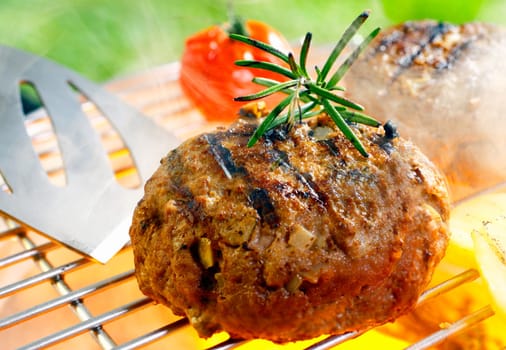 Hamburger patty grilling on the barbecue isolated on