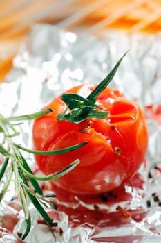 Grilled tomato and rosmary on aluminium foil