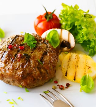 Healthy grilled patty and vegetable in a close up shot