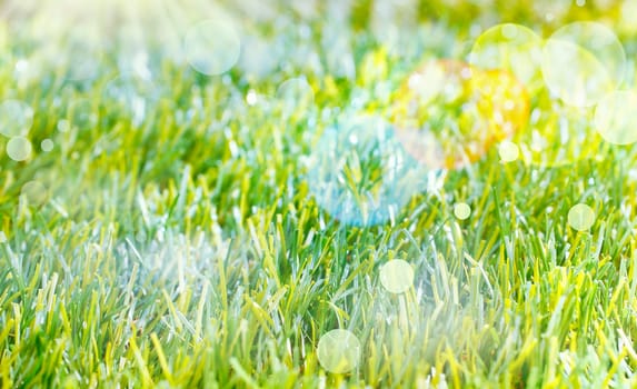 Ethereal Spring background with lens flare and bokeh over lush green grass