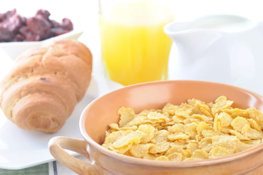 a bowl of corn flakes and milk. breakfast.