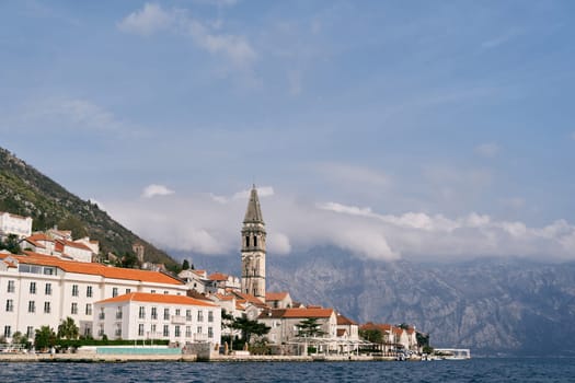 Coast of Perast with old stone houses and the bell tower of the Church of St. Nicholas. Montenegro. High quality photo