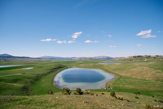 Clear blue Vrazje Lake on a green mountain valley. Montenegro. High quality photo