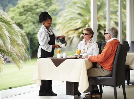 Waitress, coffee and senior couple on cafe patio on romantic date together at restaurant table. Old man, woman and server pouring drink at breakfast in luxury hospitality, hotel and relax on terrace