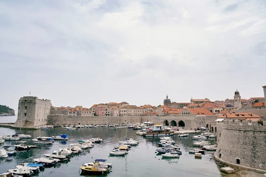 Rows of yachts are moored at the arched fortress walls of Dubrovnik. Croatia. High quality photo