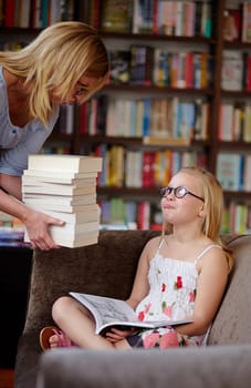 Reading, books and woman with crying child in library, learning and studying on couch for knowledge. Storytelling, mother and girl in bookstore together with story, fantasy and education on sofa