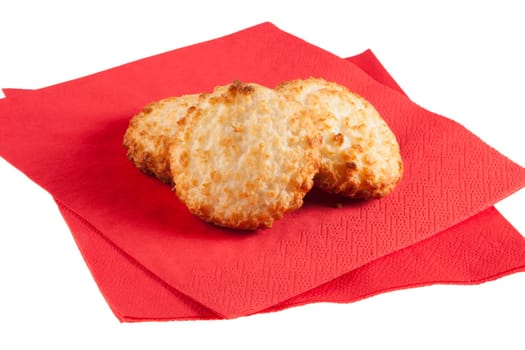 Three macaroons on red napkins with white background