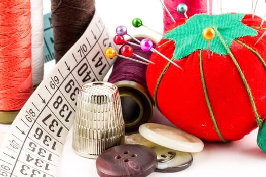 Some sewing supplies with pin, tape and meter