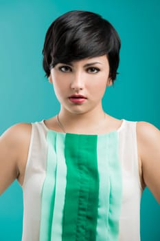 Portrait of a beautiful and fashion woman aganist a blue background