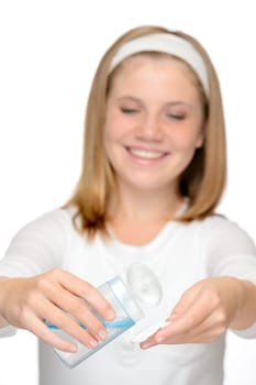 Young smiling girl applying face cleaning lotion make-up remover