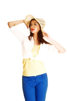 A pretty chinese woman in blue pants and a yellow top and white jacket, holding her straw hat for white background.