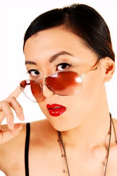 A closeup shoot of a classy young chinese woman looking over her  sunglasses for white background.