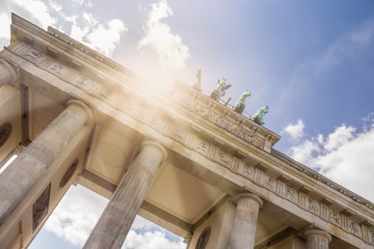 brandenburger tor with sunlight and cloudy sky