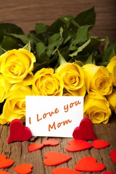 Yellow roses with lots of red hearts and an "I Love you Mom"" card"