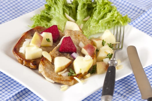 Two small minute steaks with fresh apple salad on a plate