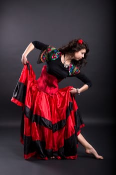 Young woman make step in spanish traditional clothes