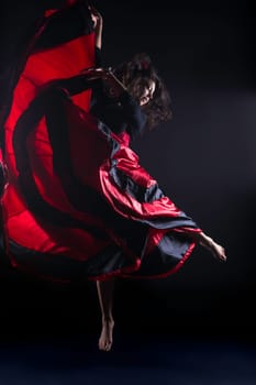 Young woman jump in spanish flamenco with passion