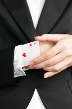 young businesswoman pulling out ace of hearts from the sleeve of her suit