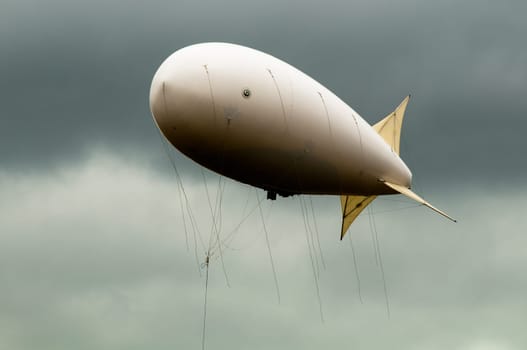 big dirigible flying in the dramatic looking sky