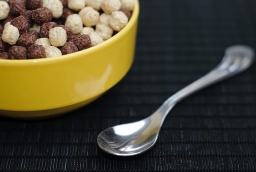 still life of healthy breakfast with cup of cereal and spoon