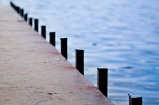 metal pier bridge over blue calm water