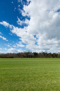 Meadow with clouds,landscape with cut lawn and sky