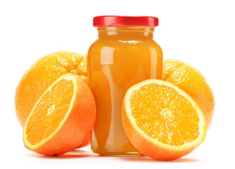 Glass and jug of orange juice, jar of jam and fruits. Variety of orange products