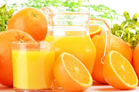 Glass and jug of orange juice and fruits