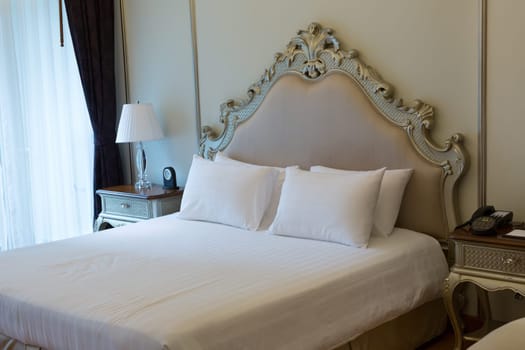 room at the luxurious double bed with carved headboard.