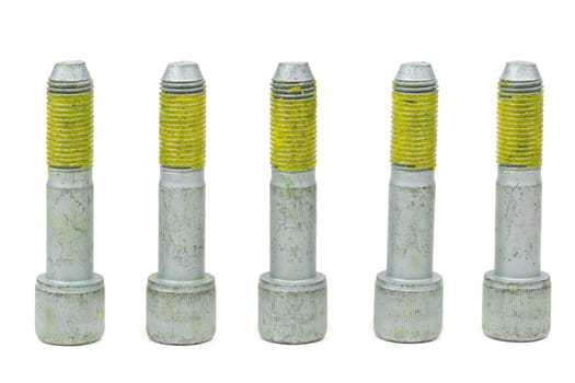 Five bolts for the car with the yellow glue on the threads. Isolate on white.