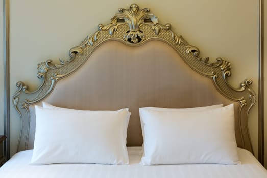 Double bed in the hotel room, golden style