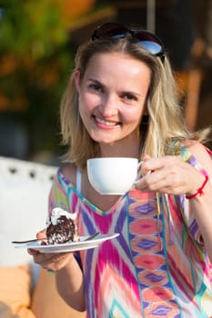 beautiful girl with a cup of coffee and cake