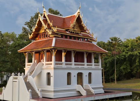 beautiful little Thai temple in the forest setting sun