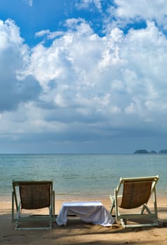 Two sunbeds on the beach with blue sky, Thailand