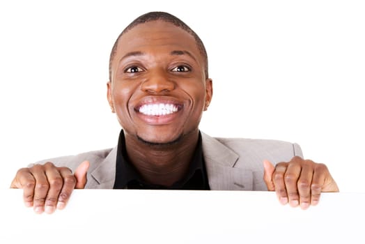 Happy successful businessman holding and showing blank advertisement. Isolated on white.