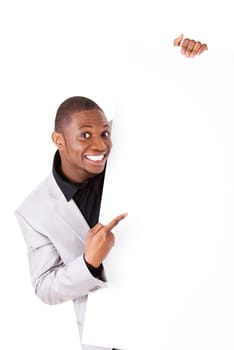 Happy successful businessman holding and showing blank advertisement. Isolated on white.