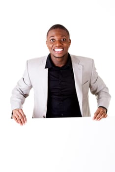 Happy successful businessman holding and showing blank advertisement. Isolated on white.