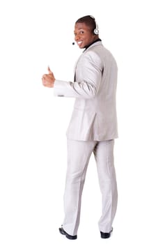 Charming customer service representative with headset on gesturing thumbs up.