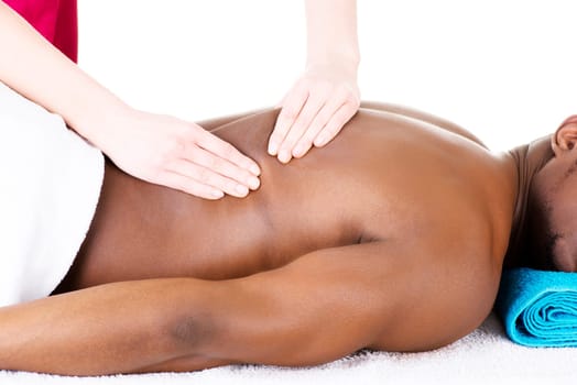 Masseur doing massage on man body in the spa salon.