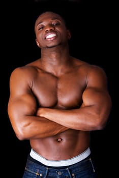 Muscular black man, against black background
