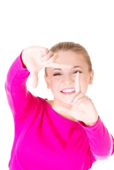 Smiling woman wearing red blouse is showing frame by hands. Happy girl with face in frame of palms. Isolated on white background.