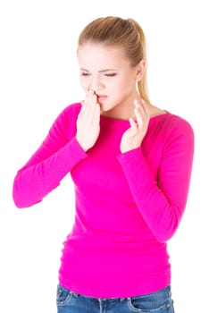 Teen woman pressing her bruised cheek with a painful expression as if she's having a terrible tooth ache.