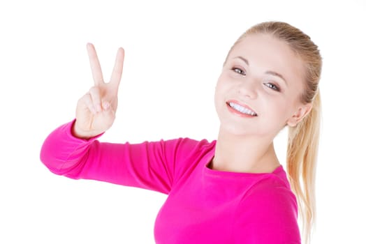 Happy young teenager girl showing victory sign ,isolated on white background
