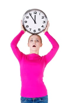 Portrait of shocked woman with clock over white background