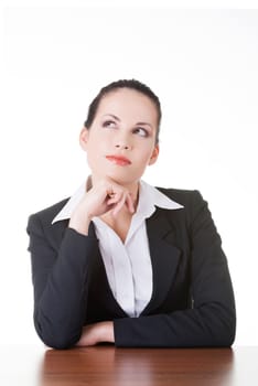 Pretty business woman in sitting at the desk and thinking, isolated on white