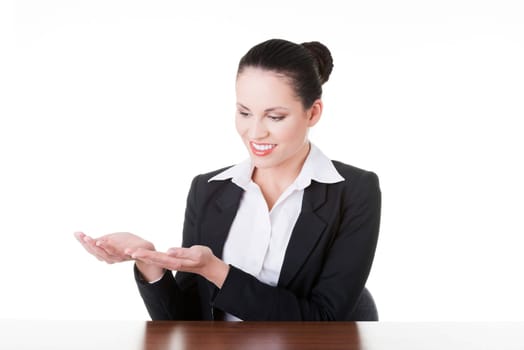 Happy young business woman showing copy space on her palm, isolated on white