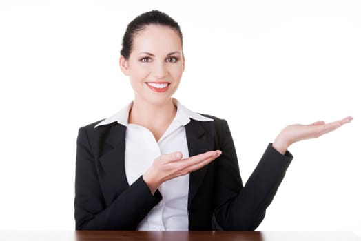 Happy young business woman showing copy space on her palm, isolated on white