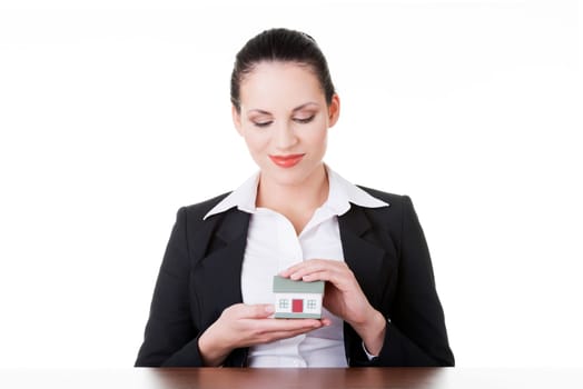 Businesswoman with house model over white - real estate loan or insurance concept